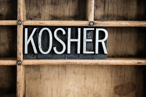 kosher in metal letters on wood background