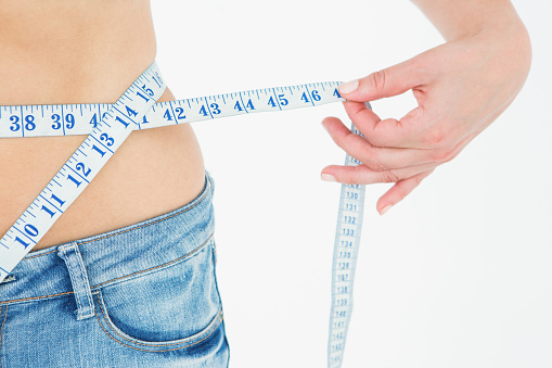 woman measuring waist