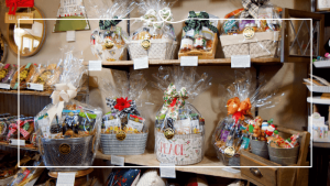 Gourmet Gift Baskets sitting on wooden shelves at Maisie Jane's