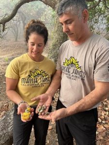 Maisie Jane and Isidro fascinated with the fresh cashews and cashew fruit in Vietnam.