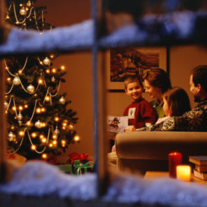 Family at Christmas viewed through window
