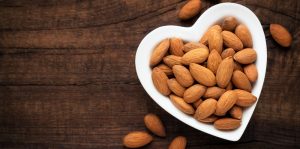 heart shaped bowl filled with almonds